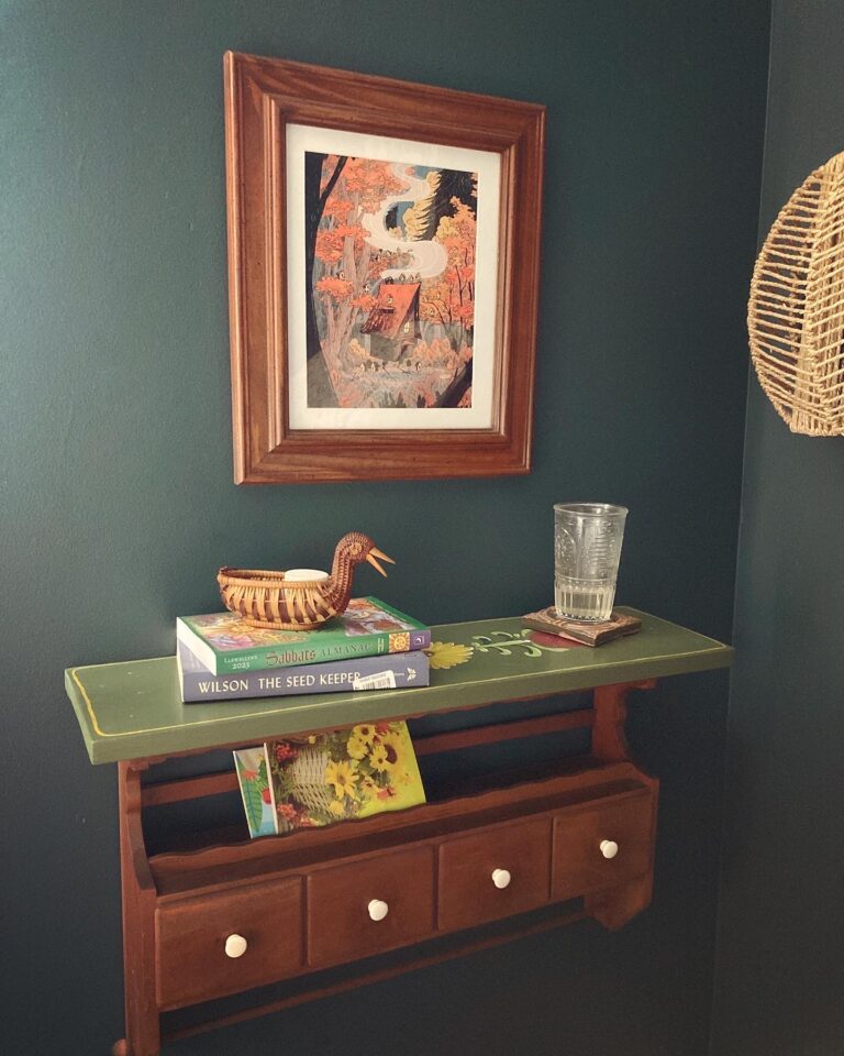 Bedside shelf with framed art above.